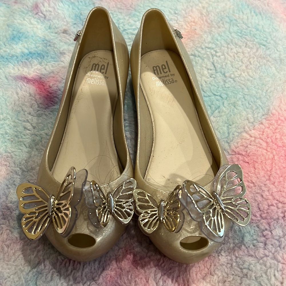 Gently used girls Mel by Melissa dress shoes. Size 12. Silver with butterflies.